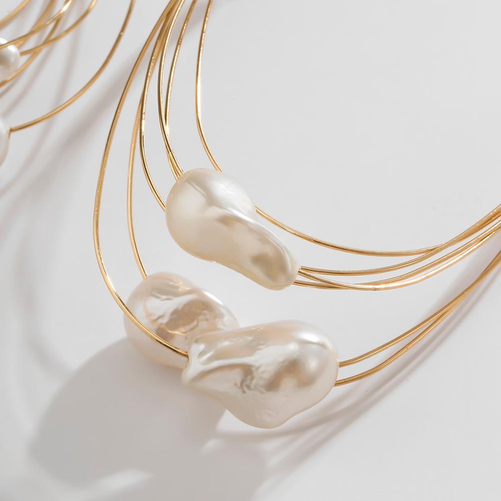 GORGEOUS GIANT BAROQUE PEARL GOLD HOOP EARRINGS featuring a clean chic design and modern white color ,perfect for dailylife/party/office/casual occasion. Styled against a white marble background displaying the detail of the baroque pearl