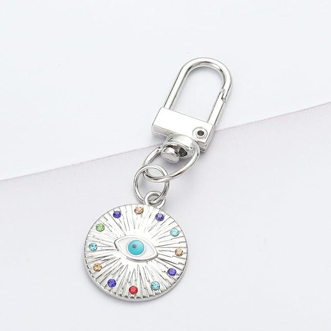 three Silver Gold Evil Eye Keychain for Women Protection Good Luck Charms Key Chain for Car Keys Holder Bag Purse featuring a clean chic eye design and silver and multi color ,perfect for daily /party/casual/office bagcharm/chain charm decoration . Styled against a white background.
