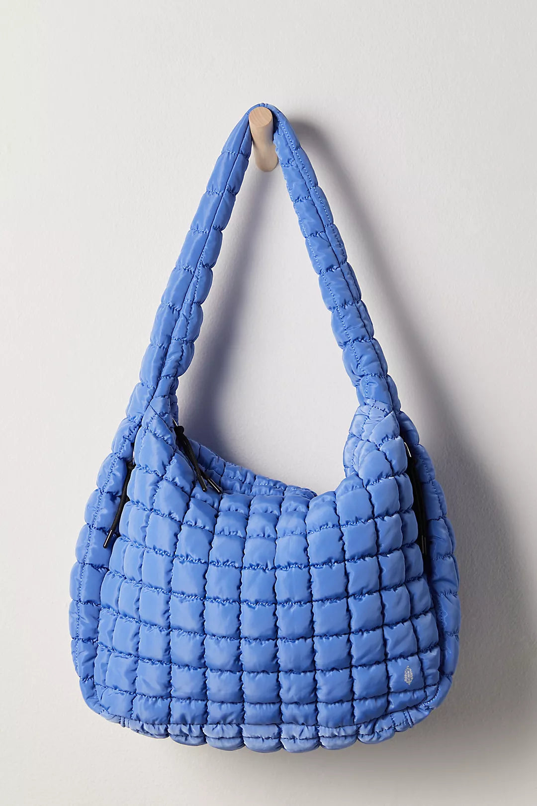 Blue quilted handbag on a light gray background freepeople coupon sale code skirt puffer bag dress white crop top girl cute clothing mindfully outfits cottagecore cotton good quality comfy chic vacation daily White quilted handbag on a white background