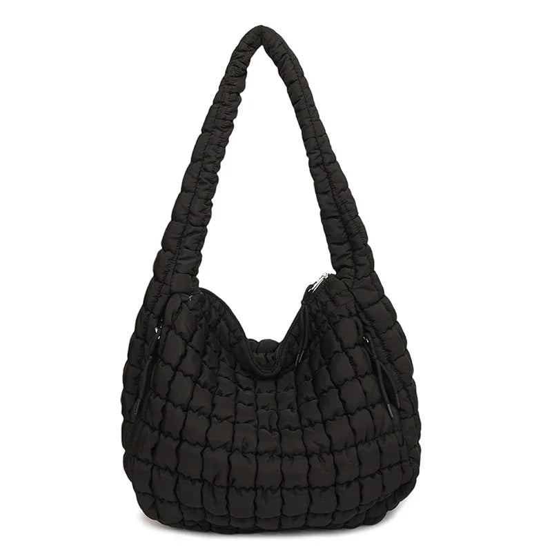 Black quilted handbag on a white background freepeople coupon sale code skirt puffer bag dress white crop top girl cute clothing mindfully outfits cottagecore cotton good quality comfy chic vacation daily White quilted handbag on a white background