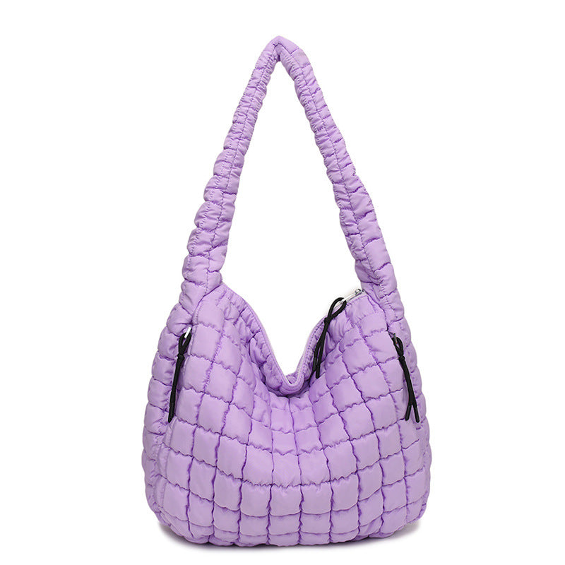 Purple quilted handbag on a white background freepeople coupon sale code skirt puffer bag dress white crop top girl cute clothing mindfully outfits cottagecore cotton good quality comfy chic vacation daily White quilted handbag on a white background