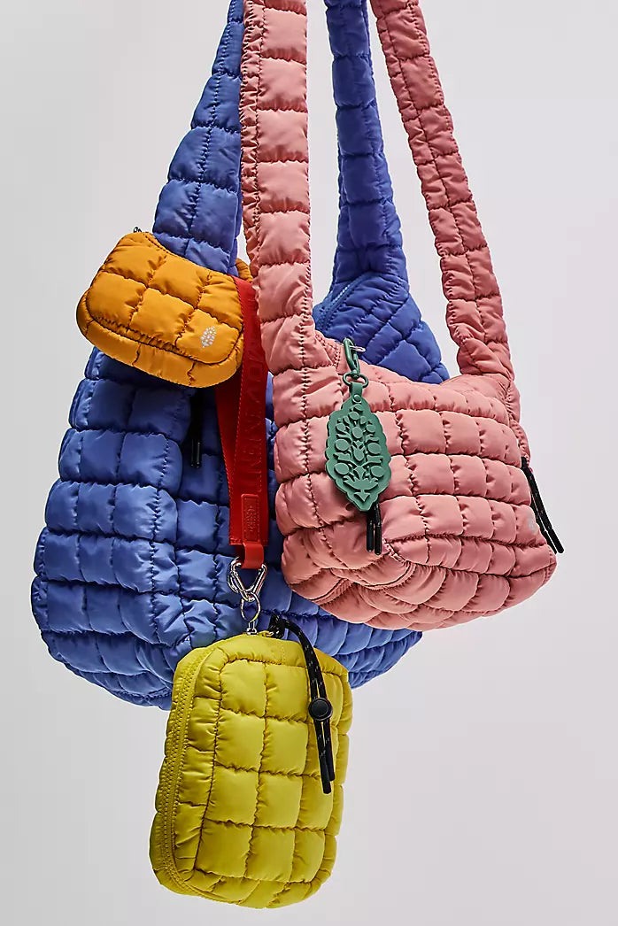 Colorful quilted handbags with leaf designs on a light gray background freepeople coupon sale code skirt puffer bag dress white crop top girl cute clothing mindfully outfits cottagecore cotton good quality comfy chic vacation daily White quilted handbag on a white background