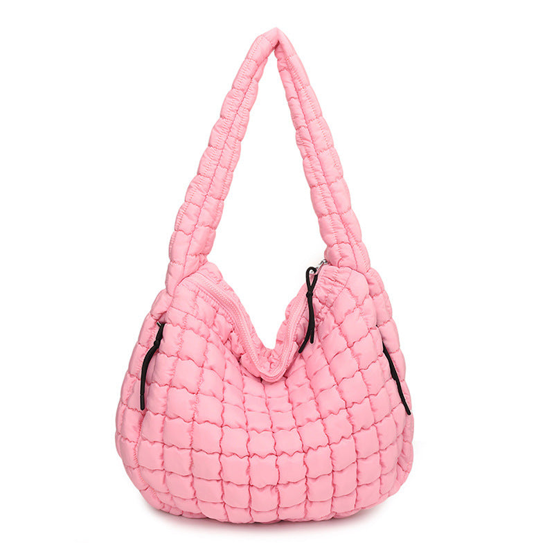 Pink quilted handbag on a white background freepeople coupon sale code skirt puffer bag dress white crop top girl cute clothing mindfully outfits cottagecore cotton good quality comfy chic vacation daily White quilted handbag on a white background