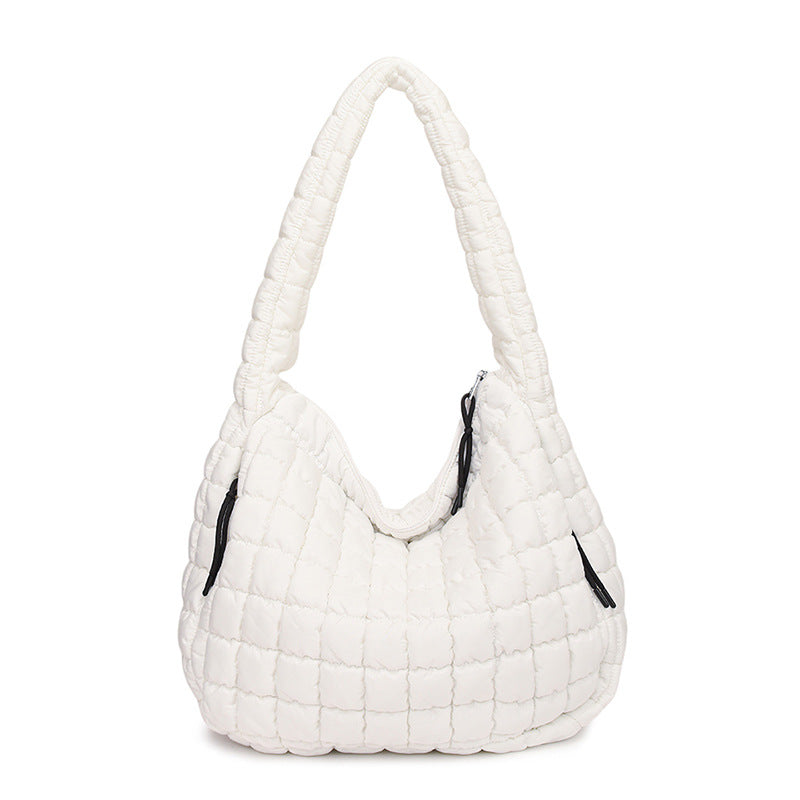 White quilted handbag on a white background freepeople coupon sale code skirt puffer bag dress white crop top girl cute clothing mindfully outfits cottagecore cotton good quality comfy chic vacation daily White quilted handbag on a white background