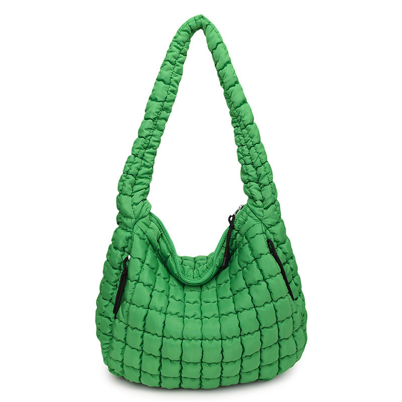 Green quilted handbag on a white background freepeople coupon sale code skirt puffer bag dress white crop top girl cute clothing mindfully outfits cottagecore cotton good quality comfy chic vacation daily White quilted handbag on a white background