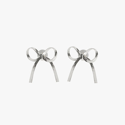 GORGEOUS SILVER BOW EARRINGS featuring a clean chic bow design and modern nature silver and black color ,perfect for dailylife/party/office/casual occasion. Styled against a white background.