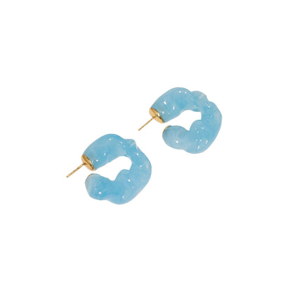 CULT STATEMENTPIECES BLUE BIO RESIN GOLD VERMEIL EARRINGS featuring a clean chic hoop design and modern jelly blue color ,perfect for dailylife/party/office/casual occasion. Styled against a white background.