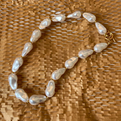 BAROQUE HOLOGRAPHIC PEARL WILMA PEARL NECKLACE featuring a clean chic design and modern white color ,perfect for dailylife/party/office/casual occasion. Styled against a paper material background.