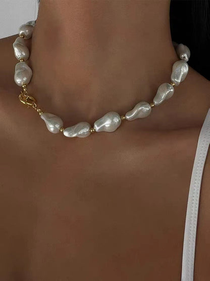 BAROQUE HOLOGRAPHIC PEARL WILMA PEARL NECKLACE featuring a clean chic design and modern white color ,perfect for dailylife/party/office occasion. Displayed in a elegant lifestyle setting with a model wearing camisole summer outfit.