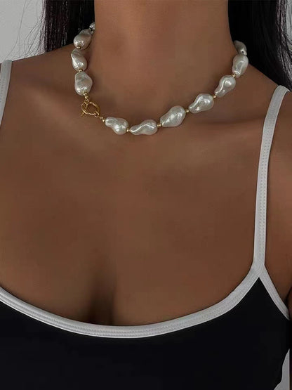 BAROQUE HOLOGRAPHIC PEARL WILMA PEARL NECKLACE featuring a clean chic design and modern white color ,perfect for dailylife/party/office occasion. Displayed in a elegant lifestyle setting with a model wearing camisole summer outfit.