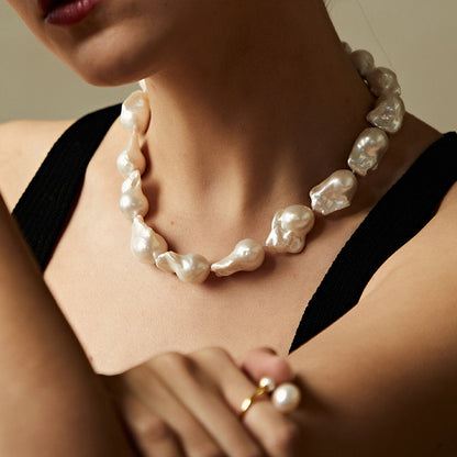 BAROQUE HOLOGRAPHIC PEARL WILMA PEARL NECKLACE featuring a clean chic design and modern white color ,perfect for daily/party/office/casual occasion. Displayed in a elegant lifestyle setting with a model wearing camisole summer outfit.