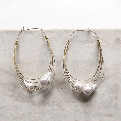 GORGEOUS GIANT BAROQUE PEARL GOLD HOOP EARRINGS featuring a clean chic design and modern white color ,perfect for dailylife/party/office/casual occasion. Styled against a white marble background.