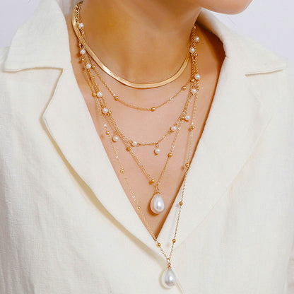 MULTI LAYER WATER DROP PEARL PENDANT WEDDING NECKLACE featuring a clean chic design and modern nature gold and pearl color ,perfect for dailylife/party/office/casual occasion. Displayed in a chic lifestyle setting with a model wearing a white top .