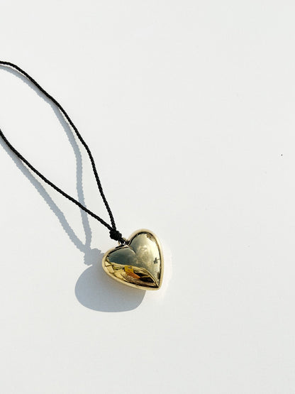 Puffy 3D Heart Necklace featuring a clean chic design and modern nature gold and black color ,perfect for dailylife/party/office/casual occasion. Styled against a white background.