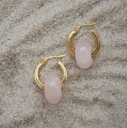 ROSIE ROSE QUARTZ HOOP EARRINGS Delicate rose quartz hoop earrings featuring polished gemstones and a sleek metal finish, adding a touch of elegance and charm to any look