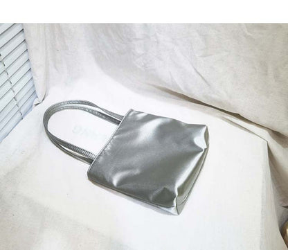 MILA LITTLE SILK BAG IN silver Elegant silk tote handbag with a smooth finish, spacious interior, and sturdy handles, perfect for adding a touch of luxury to any outfit