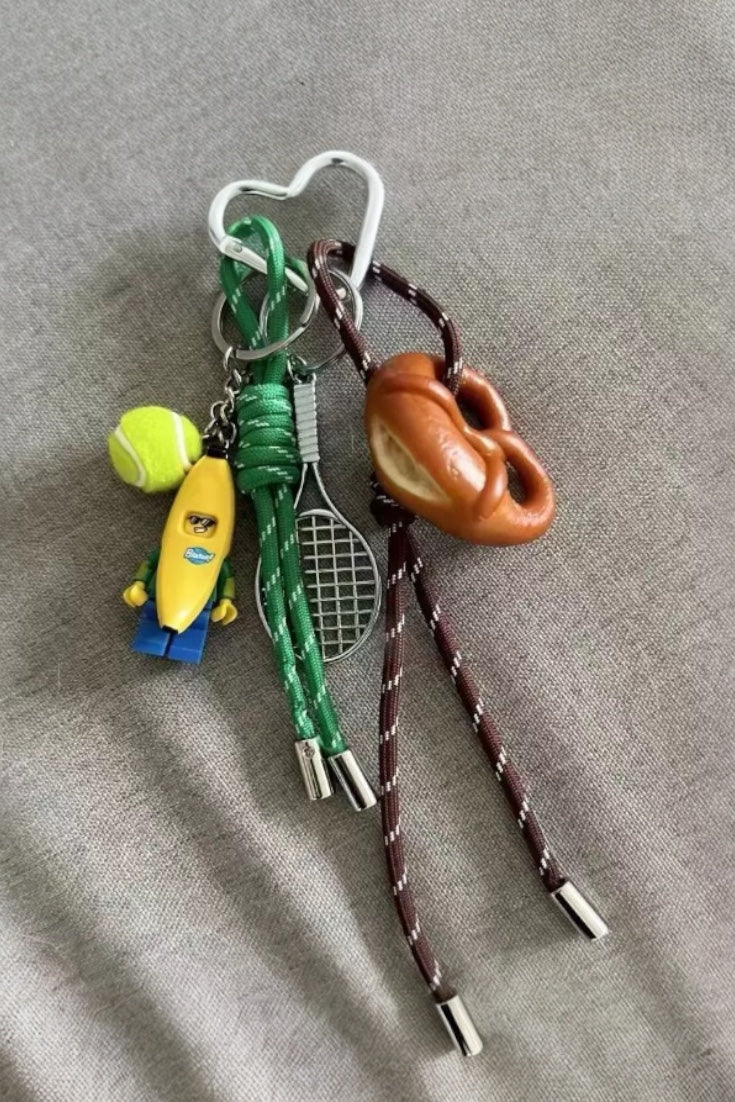 Premium tennis bananaman pretzel bow  bag charm, handcrafted in a unique character design, fashionable pink ornament for bags and gifts