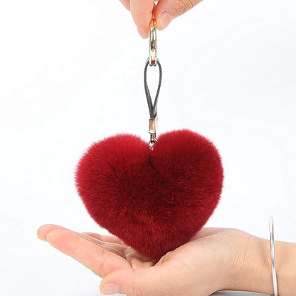 Genuine Rex Rabbit Hair Fur Pompom Keychain Heart Shaped Bag Charm Ring Fluffy Fur Ball featuring a clean chic design and fluffy red classic color ,perfect for daily /party/casual/office bagcharm/chain charm decoration . Styled against a white background.