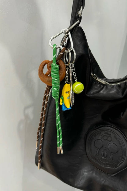 Premium tennis bananaman pretzel bow  bag charm, handcrafted in a unique character design, fashionable pink ornament for bags and gifts