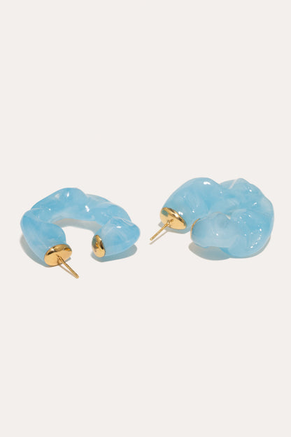 CULT STATEMENTPIECES BLUE BIO RESIN GOLD VERMEIL EARRINGS featuring a clean chic hoop design and modern jelly blue color ,perfect for dailylife/party/office/casual occasion. Styled against a white background.