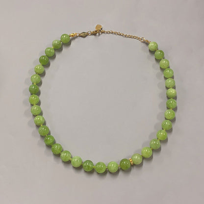 SOPHIA GREEN BOWL BEACH BALI NECKLACE featuring a clean chic design of Dyed green quartz & Glass beads in middle size and vintage green color with gold necklace clasp ,perfect for dailylife/party/office/casual occasion. Styled against a white background.