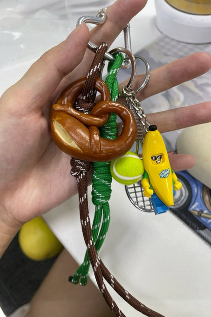 Premium tennis bananaman pretzel bow  bag charm, handcrafted in a unique character design, fashionable pink ornament for bags and gifts